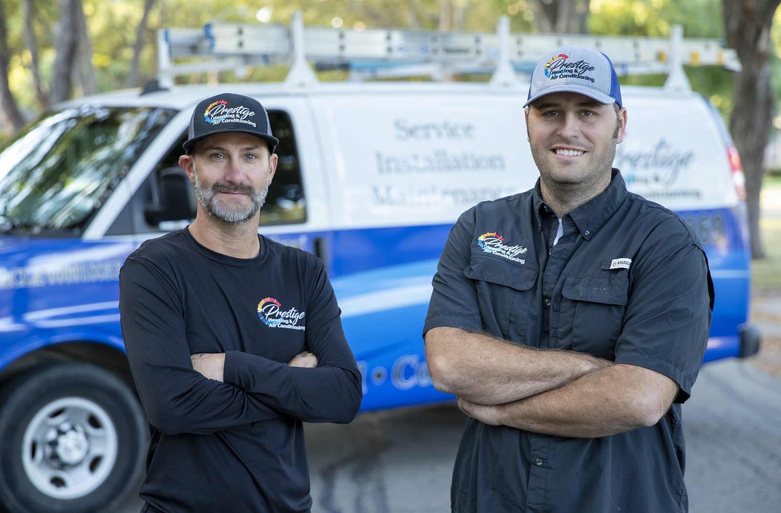 Prestige Heating & Air Conditioning technicians in front of a service van in Wichita Falls, Texas