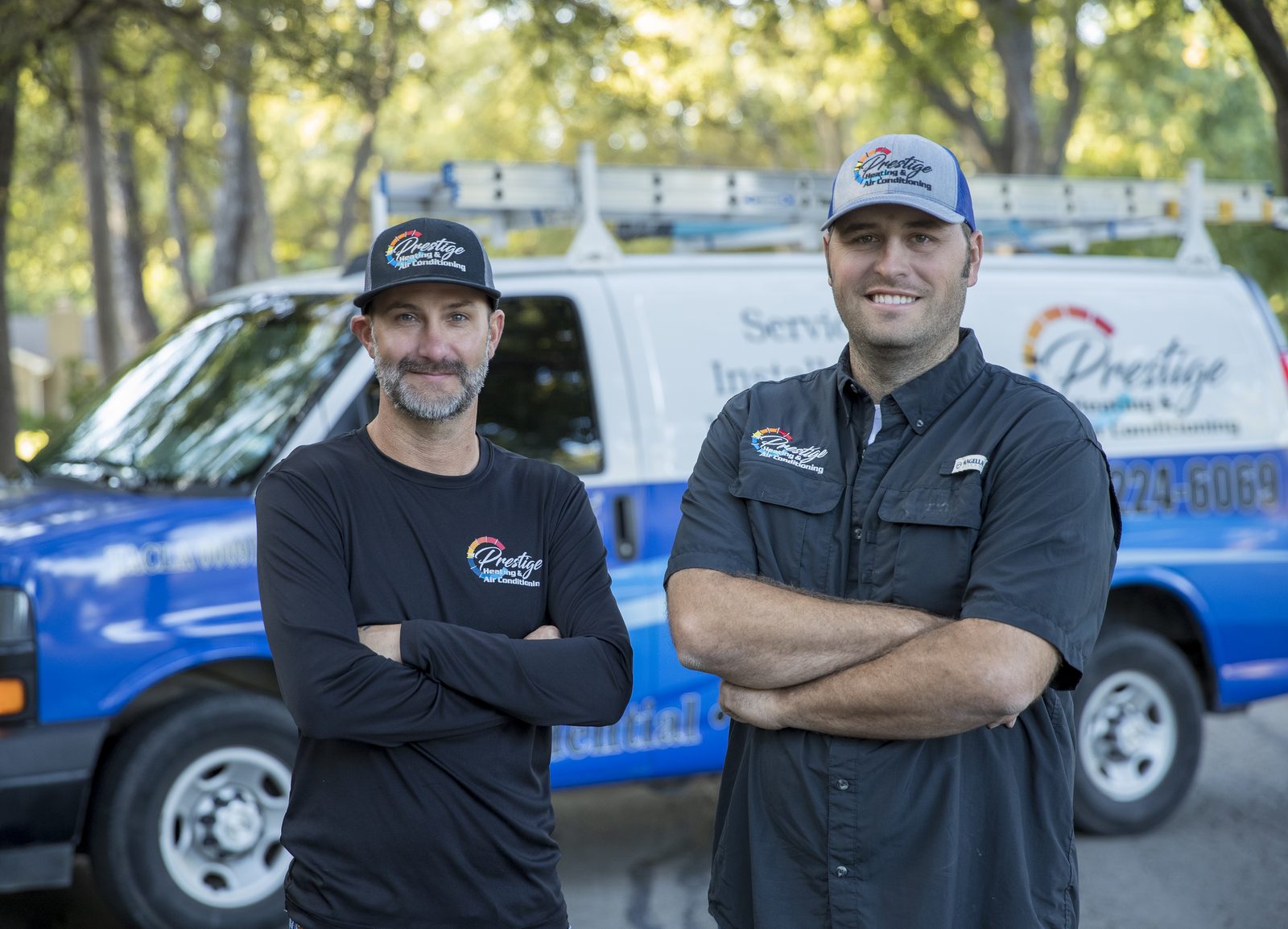 Two Prestige Heating & Air Conditioning technicians standing together in Wichita Falls, Texas